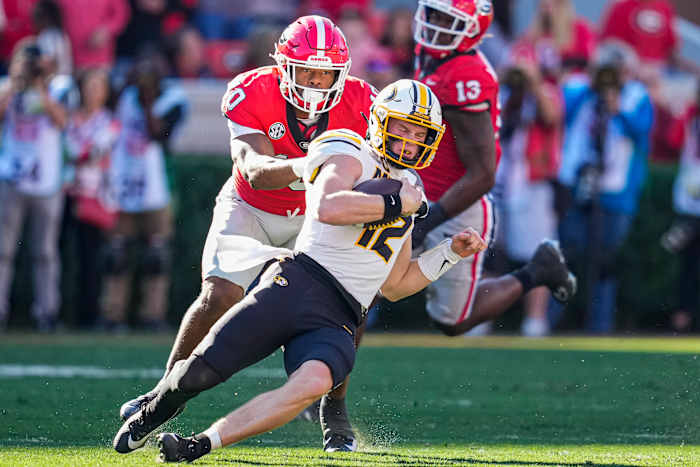 Nov 4, 2023; Athens, Georgia, USA; Missouri Tigers quarterback Brady Cook (12) runs against Georgia Bulldogs linebacker Jamon Dumas-Johnson (10) during the first half at Sanford Stadium. Mandatory Credit: Dale Zanine-USA TODAY Sports